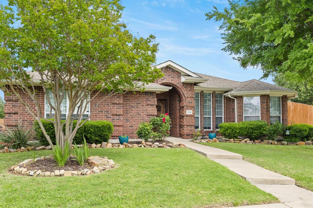 7210 Mercurys Road Rowlett, TX 75089 - Photo 3 of 26 a front view of a house with a yard