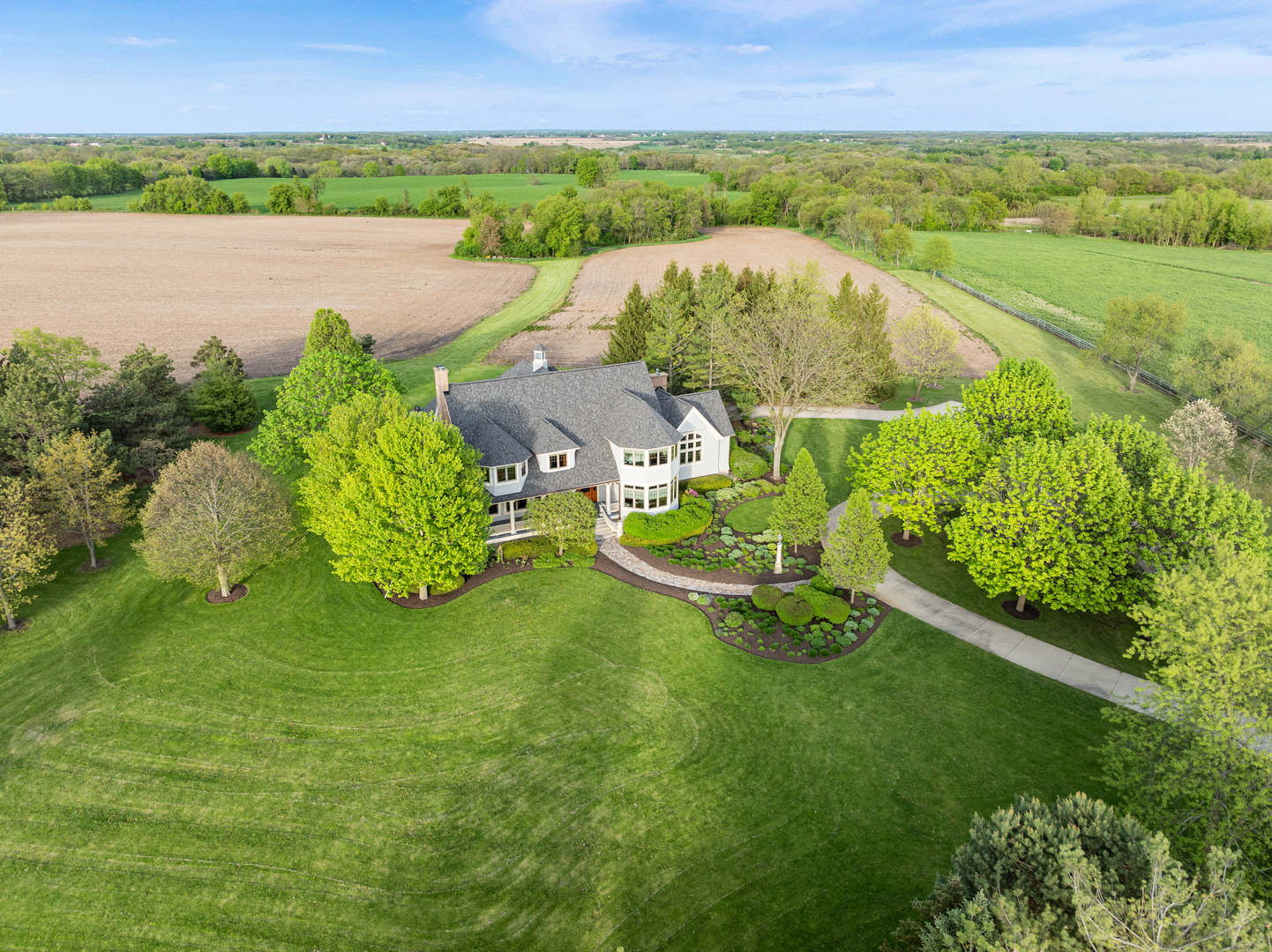 an aerial view of ocean with residential house with outdoor space and trees around