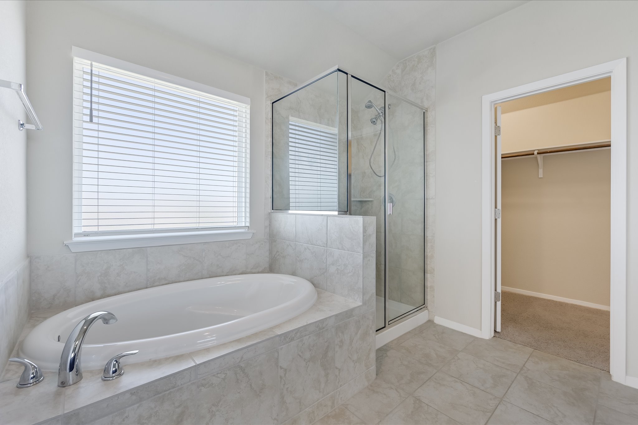 201 Spiny Lizard Lane San Marcos, TX 78666 - Photo 13 of 20 a bathroom with a tub shower and a window
