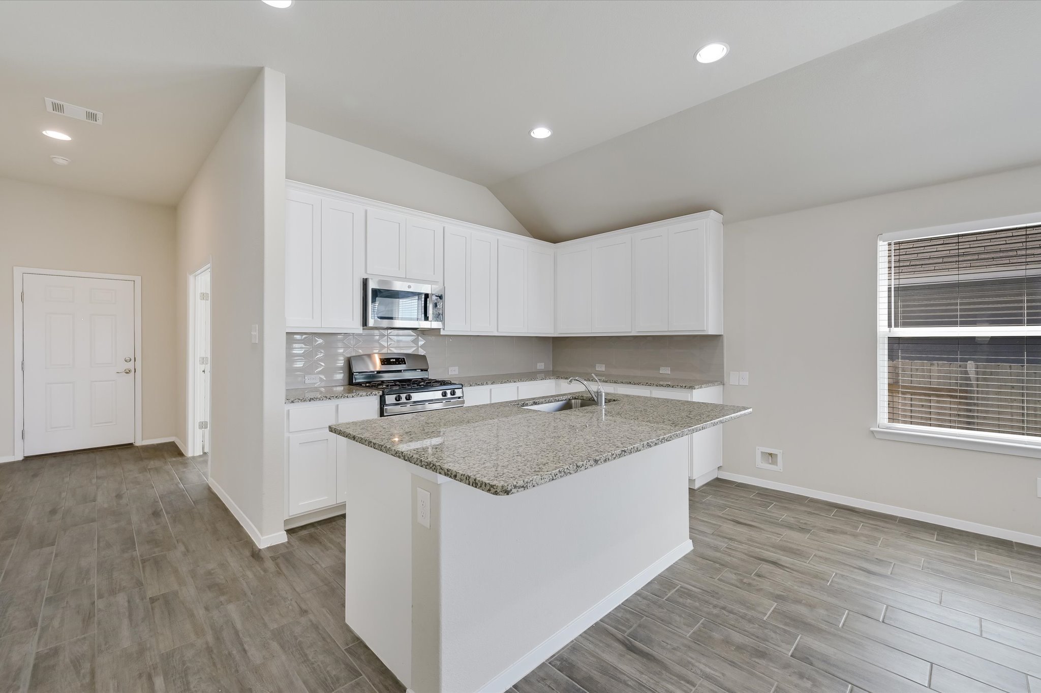 201 Spiny Lizard Lane San Marcos, TX 78666 - Photo 2 of 20 a kitchen with a sink stove and microwave