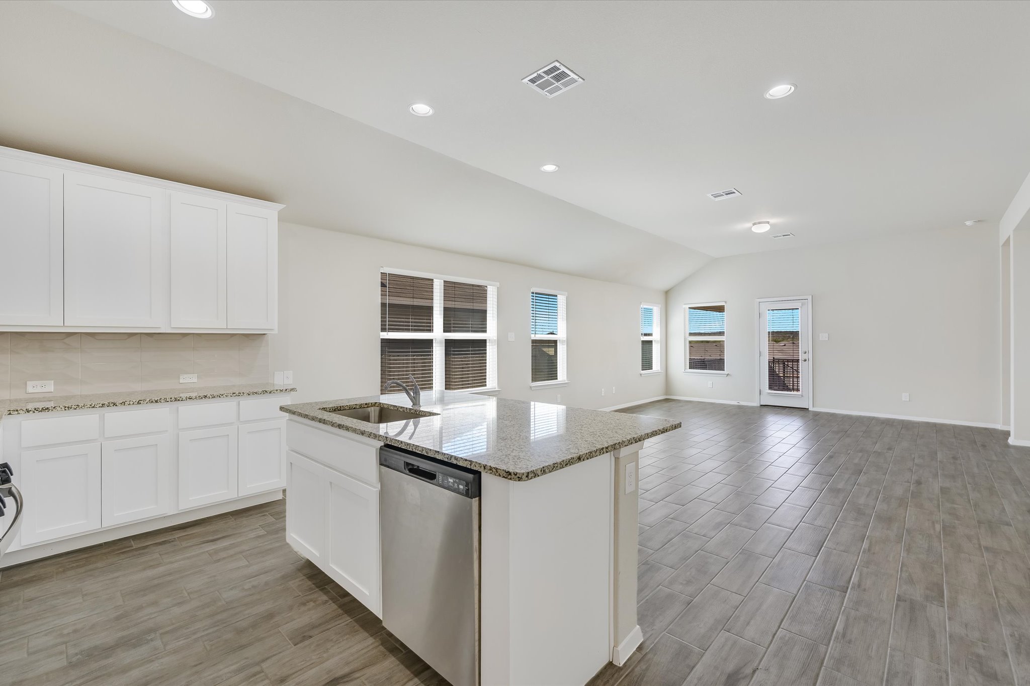 201 Spiny Lizard Lane San Marcos, TX 78666 - Photo 4 of 20 a kitchen with granite countertop a stove and cabinets