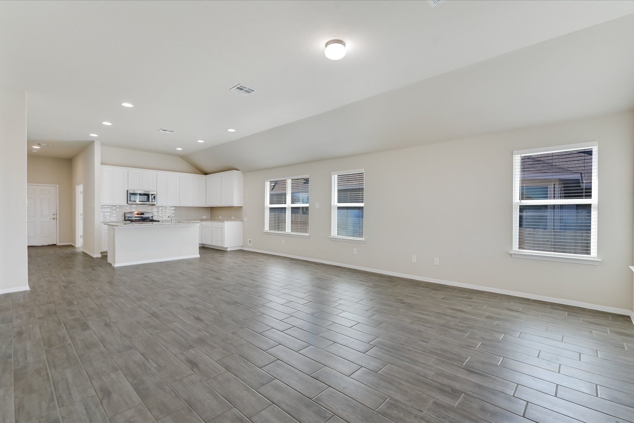201 Spiny Lizard Lane San Marcos, TX 78666 - Photo 5 of 20 a view of a kitchen with a sink wooden cabinets and a window