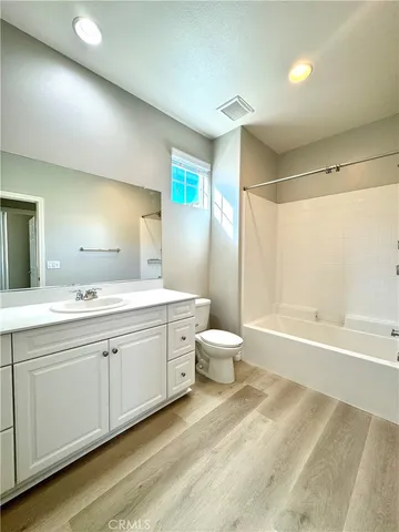 a bathroom with a double vanity sink toilet and shower