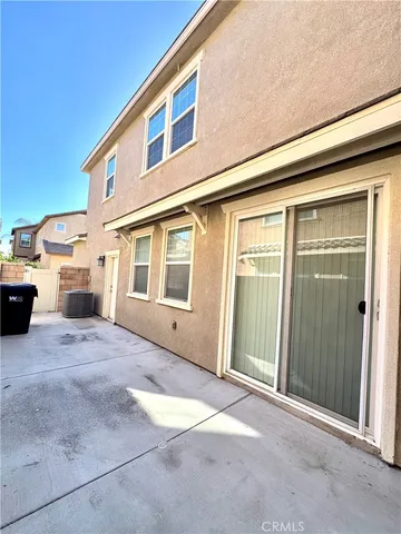 a view of a house with a wooden fence