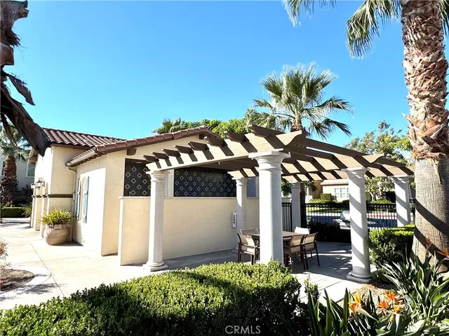 a view of swimming pool with outdoor seating and a patio