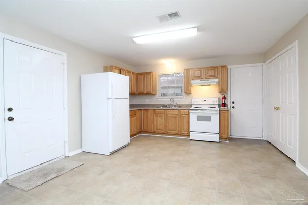 a kitchen with white cabinets and white appliances