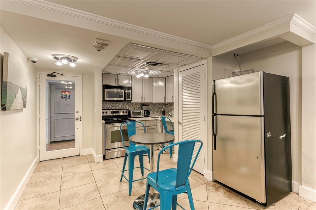 2900 Northeast 30th Street, Unit B2 Fort Lauderdale, FL 33306 - Photo 25 of 31 a kitchen with stainless steel appliances granite countertop a refrigerator and a stove top oven