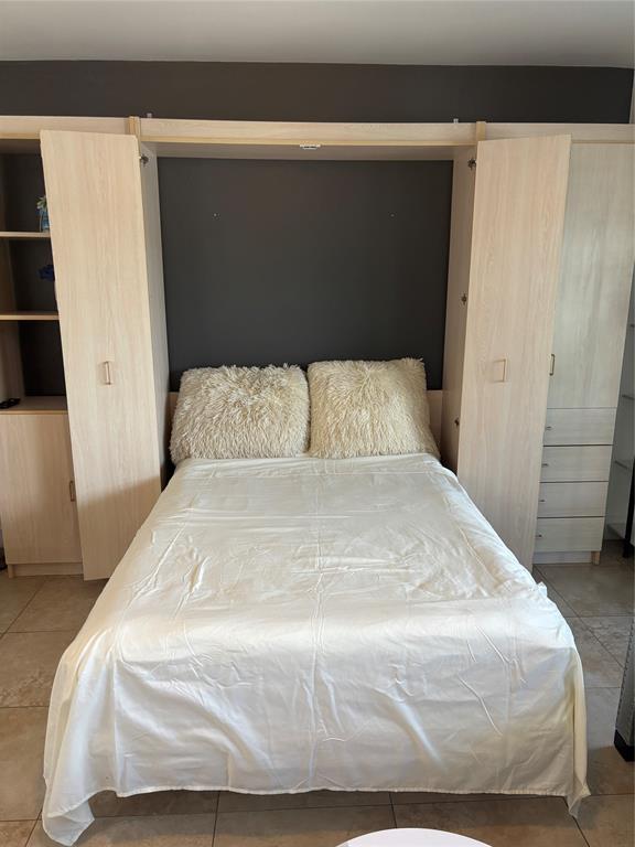 2900 Northeast 30th Street, Unit B2 Fort Lauderdale, FL 33306 - Photo 30 of 31 a large white bed in a small room