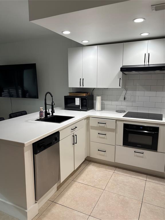 2900 Northeast 30th Street, Unit B2 Fort Lauderdale, FL 33306 - Photo 4 of 31 a kitchen with a sink stove and cabinets