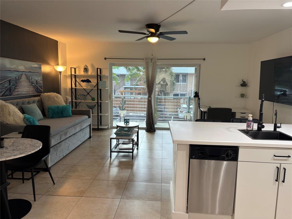 2900 Northeast 30th Street, Unit B2 Fort Lauderdale, FL 33306 - Photo 8 of 31 a living room with furniture a flat screen tv and a large window