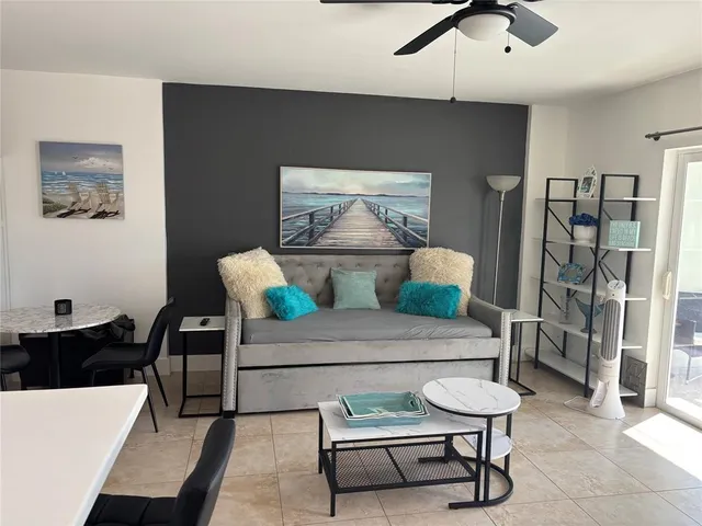 a living room with furniture and a lamp