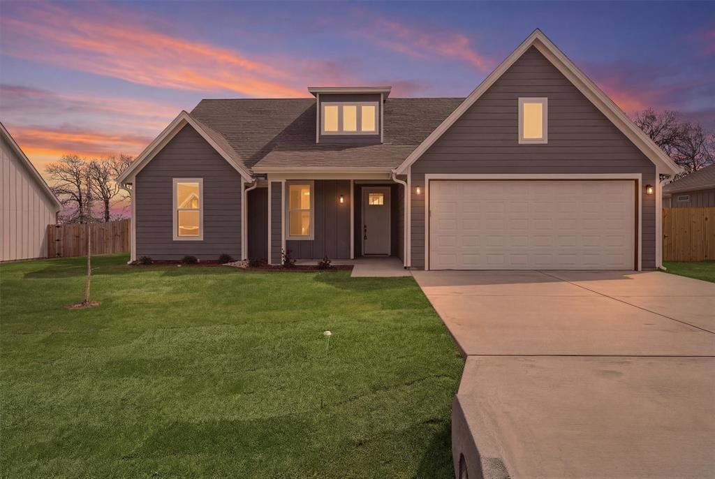 421 Red Bud Lane Tolar, TX 76476 - Photo 1 of 40 a front view of a house with a yard and garage