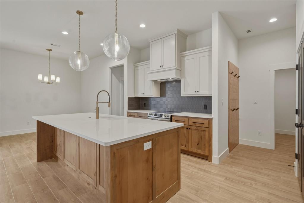 421 Red Bud Lane Tolar, TX 76476 - Photo 13 of 40 a kitchen with a sink a stove a refrigerator and cabinets