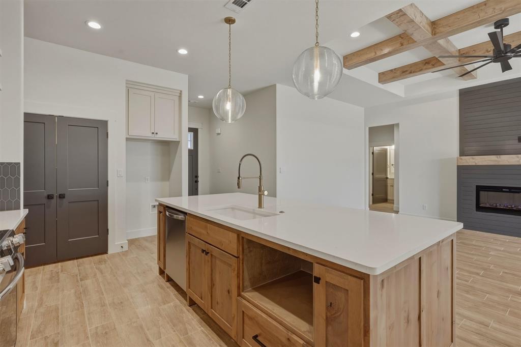 421 Red Bud Lane Tolar, TX 76476 - Photo 15 of 40 a kitchen with a sink a stove a refrigerator and cabinets
