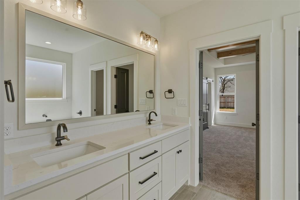 421 Red Bud Lane Tolar, TX 76476 - Photo 24 of 40 a bathroom with a sink and a mirror