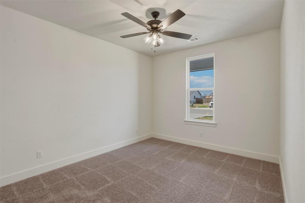 421 Red Bud Lane Tolar, TX 76476 - Photo 28 of 40 an empty room with windows and chandelier fan