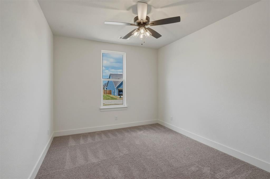 421 Red Bud Lane Tolar, TX 76476 - Photo 29 of 40 an empty room with a window and a fan