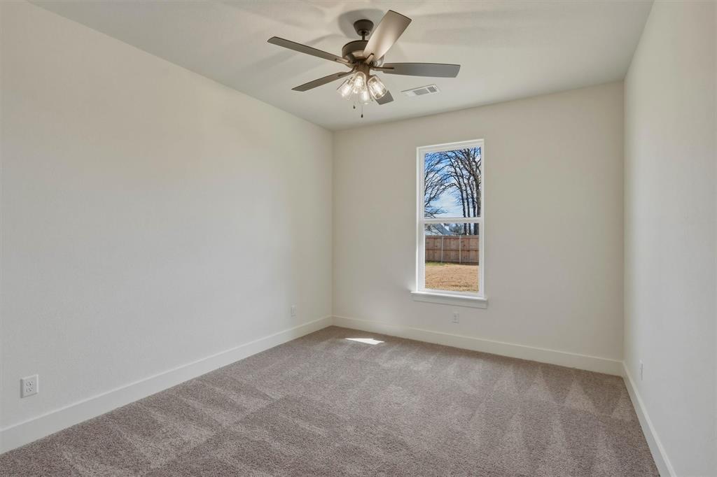 421 Red Bud Lane Tolar, TX 76476 - Photo 30 of 40 an empty room with a window and a ceiling fan