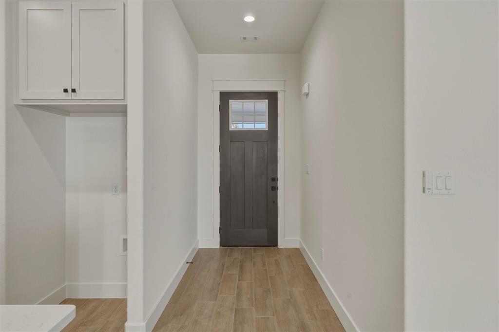 421 Red Bud Lane Tolar, TX 76476 - Photo 5 of 40 a view of a hallway with wooden floor