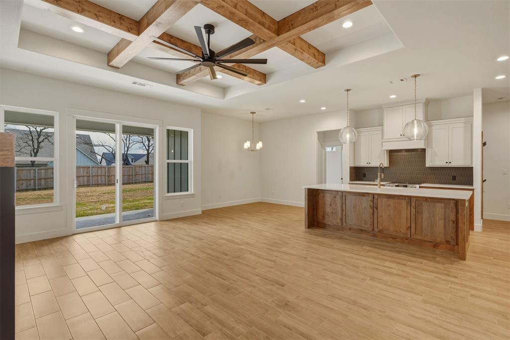 421 Red Bud Lane Tolar, TX 76476 - Photo 7 of 40 a view of an empty room with kitchen appliances and a ceiling fan