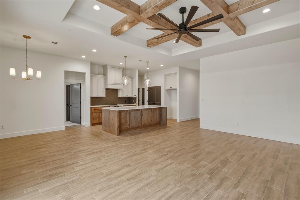 421 Red Bud Lane Tolar, TX 76476 - Photo 8 of 40 a view of a kitchen with a sink and a refrigerator