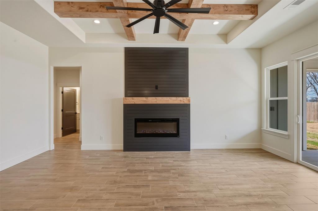 421 Red Bud Lane Tolar, TX 76476 - Photo 9 of 40 a view of an empty room with a fireplace and a window