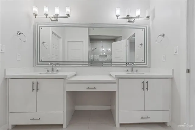 a bathroom with a sink vanity and a mirror