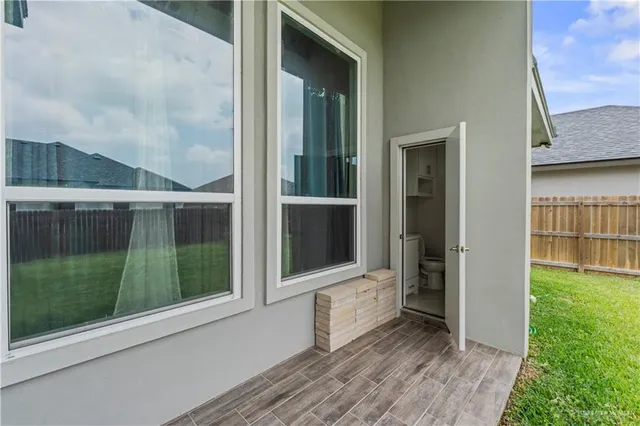 an aerial view of residential houses with outdoor space and ocean view