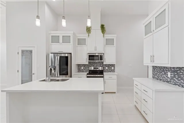a view of kitchen with furniture and refrigerator
