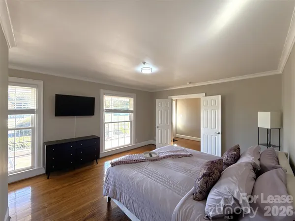 a bedroom with a large bed and a large window