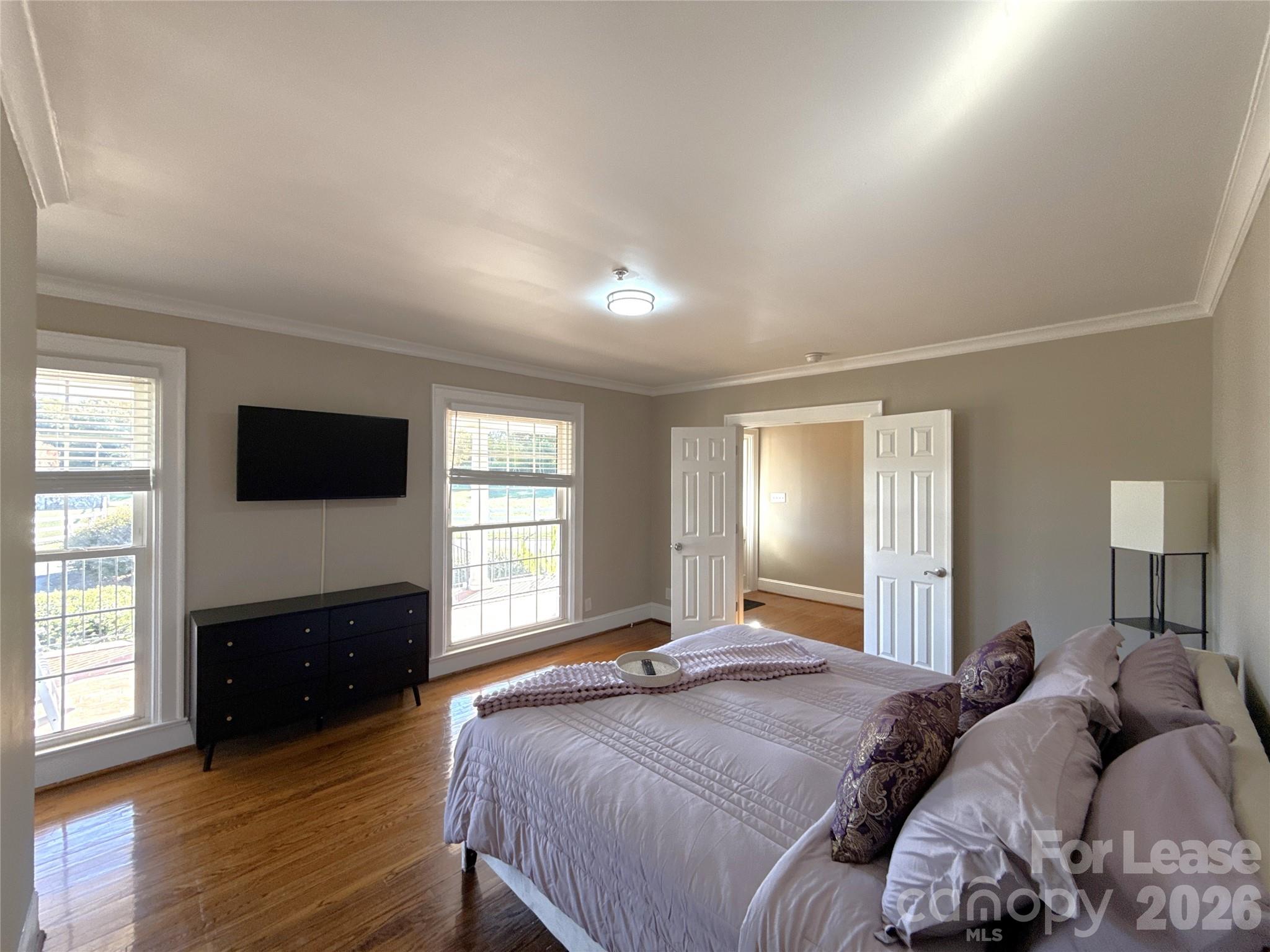 14009 Thompson Road Charlotte, NC 28227 - Photo 19 of 42 a bedroom with a bed and a flat screen tv