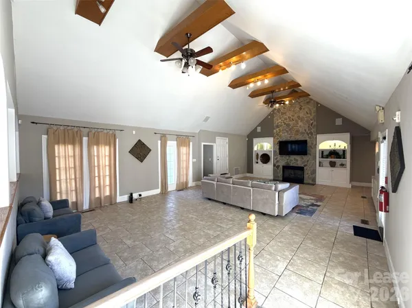 a dining room with furniture a chandelier and window