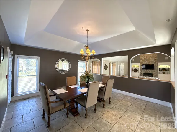 a view of a dining room with furniture and chandelier