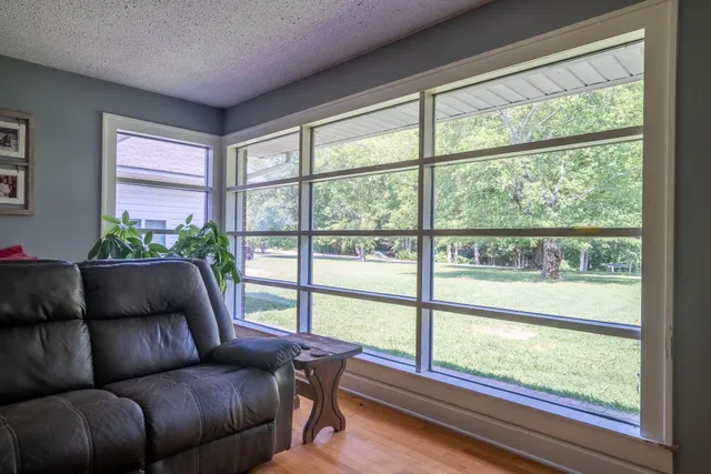 a living room with couch and a large window