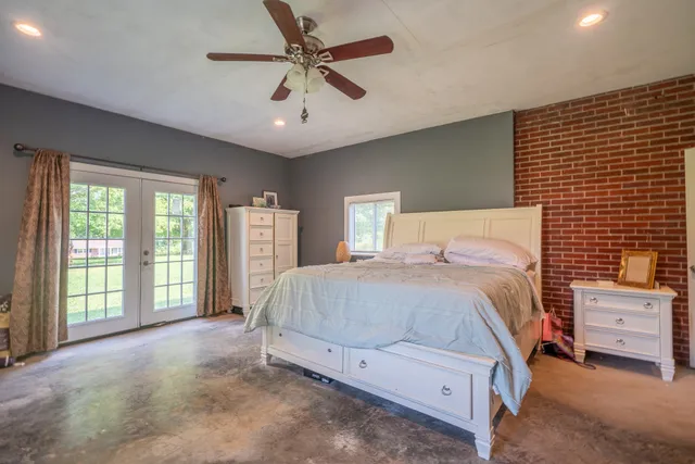 a spacious bedroom with a bed and a large window