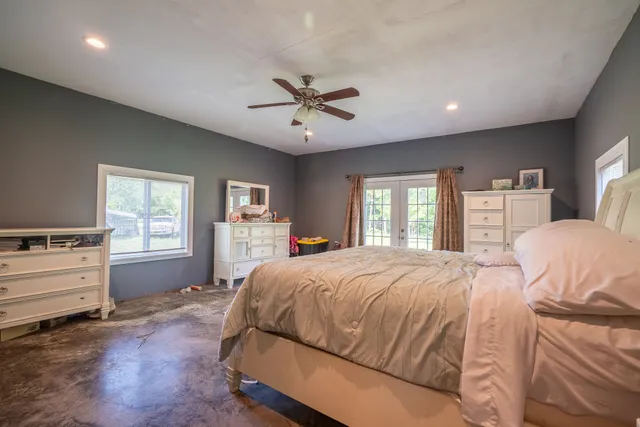 a bedroom with a bed and wooden floor