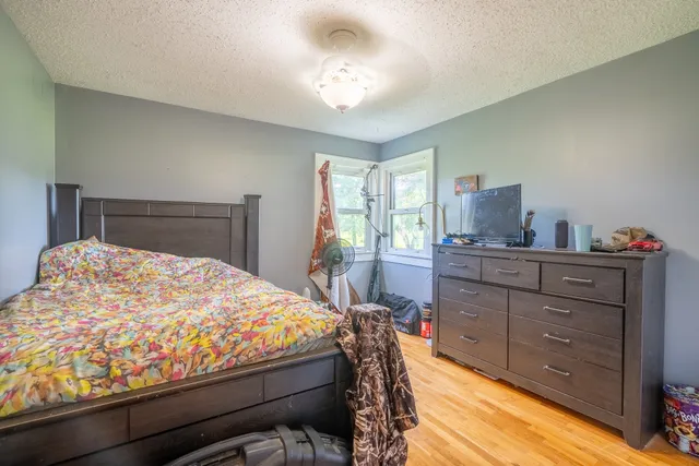 a bedroom with a bed and a dresser