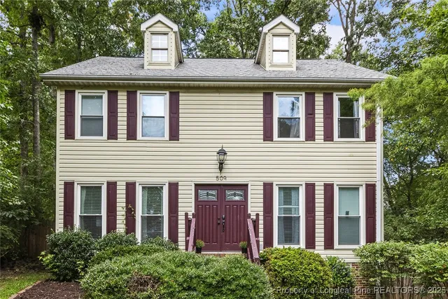 a front view of a house with a garden
