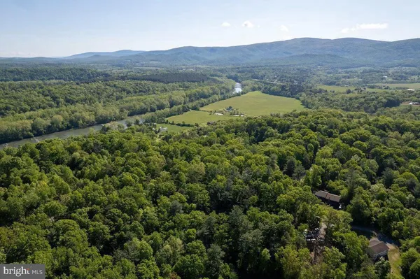 a view of a lush green hillside and a building
