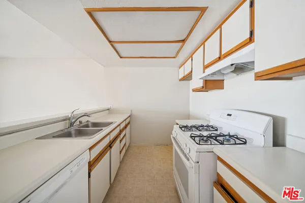 a kitchen that has a sink and a stove