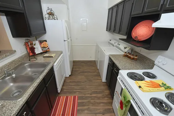 a utility room with sink dryer and washer