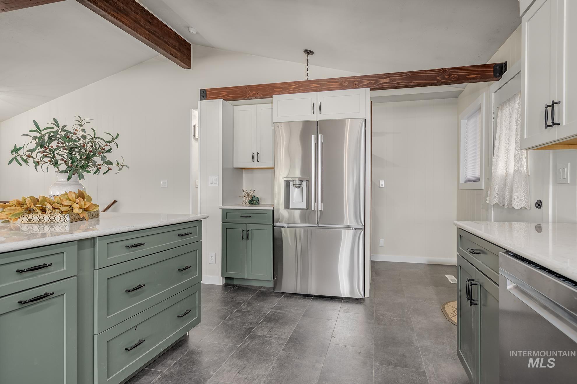 748 Pringle Road Weiser, ID 83672 - Photo 10 of 47 Kitchen featuring a stainless steel refrigerator, white countertops, two-tone cabinetry, wood-look ceiling beams, and dark tile flooring