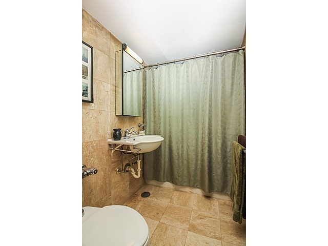 253 East Delaware Place, Unit 5E Chicago, IL 60611 - Photo 5 of 17 a bathroom with a sink toilet and shower