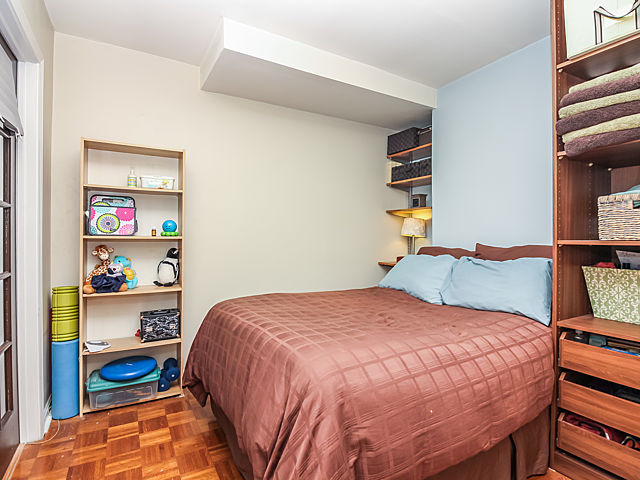 253 East Delaware Place, Unit 5E Chicago, IL 60611 - Photo 7 of 17 a bedroom with a bed and a bookshelf