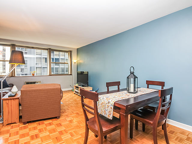 253 East Delaware Place, Unit 5E Chicago, IL 60611 - Photo 8 of 17 a dining room with a table and chairs