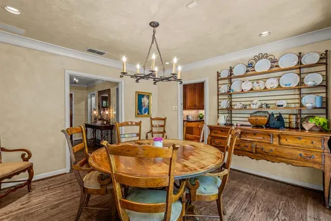 a view of a dining room with furniture and chandelier