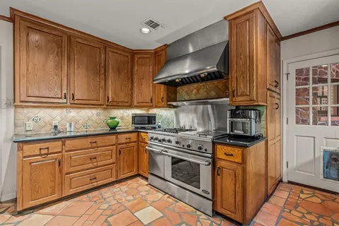 a kitchen with stainless steel appliances granite countertop a stove and a sink
