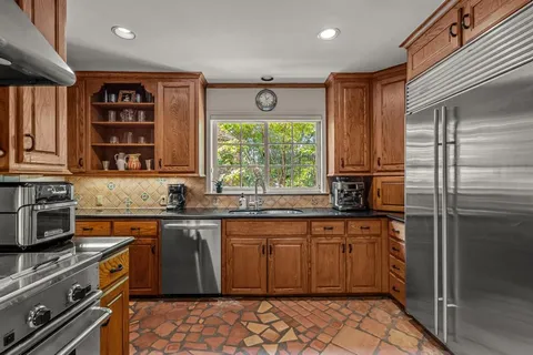 a kitchen with a sink stove and cabinets