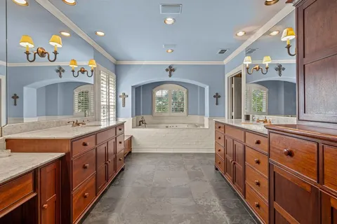 a large bathroom with a large tub and sink