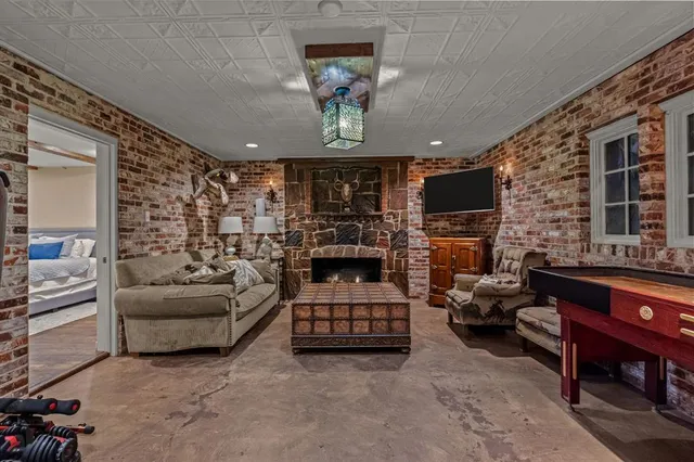 a living room with furniture a fireplace and a flat screen tv